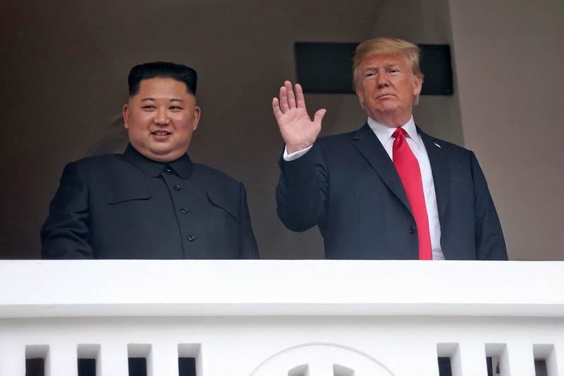 US President Donald Trump, right, waves with North Korean leader Kim Jong Un at the Capella resort on Sentosa Island in Singapore following their bilateral meeting. (AP image)