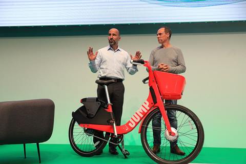 Dara Khosrowshahi, chief executive officer of Uber Technologies Inc., left, presents the JUMP ride sharing hire-bicycle alongside Christoph Keese, chief executive officer of Axel Springer hy GmbH, during the Noah Technology Conference in Berlin, Germany, on Wednesday, June 6, 2018. Photographer: Krisztian Bocsi/Bloomberg
