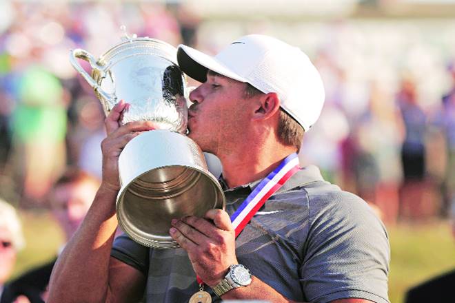 Brooks Koepka kisses the Golf Champion Trophy after winning the US Open Golf Championship last month in New York (AP/PTI)