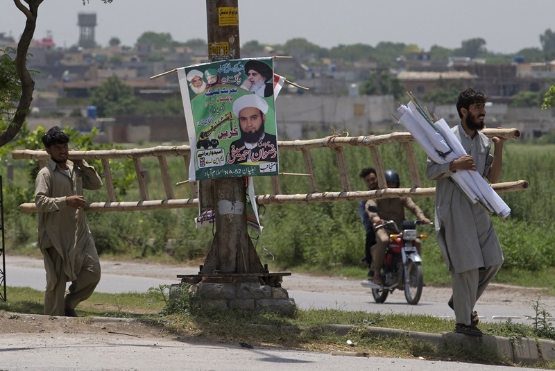 A poster for the Pakistani radical political party, Tehreek-i-Labbaik Ya Rasool Allah, center, are displayed alongside a banner for the Pakistan Peoples Party, in Islamabad. Winning even a small number of seats would be huge for Tehreek-e-Labbaik Pakistan and could set back lawmakers' efforts to curb the use of a controversial blasphemy law, which carries an automatic death penalty, to settle disputes, frighten or intimidate opponents simply by levelling accusations of insulting Islam's prophet.