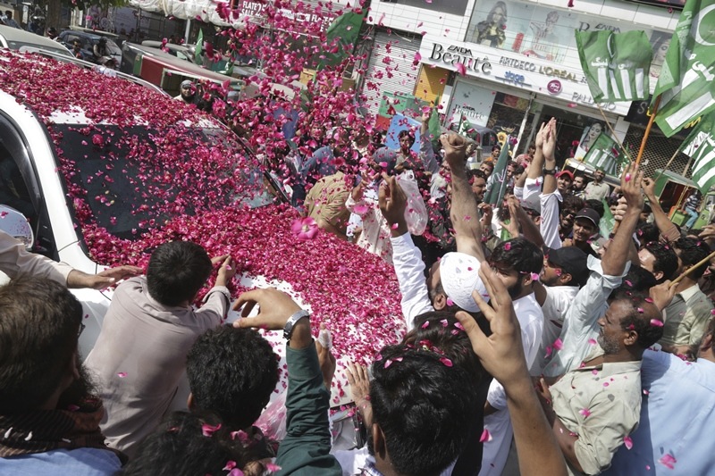 People shower rose petals on a vehicle of Hafiz Saeed, head of the Jamaat-ud-Dawa organisation and founder of Lashkar-e-Taiba. This is the scene as he arrived to inaugurate an election office of the newly formed political party, Allah-o-Akbar Tehreek, in Lahore. Saeed carries $10 million US bouty. The Allah-o-Akbar Tehreek has more than 260 candidates contesting the polls. In Lahore and elsewhere across Punjab province, where 60 per cent of the country's 200 million people live, its campaign posters prominently feature Saeed. (AP Photo)