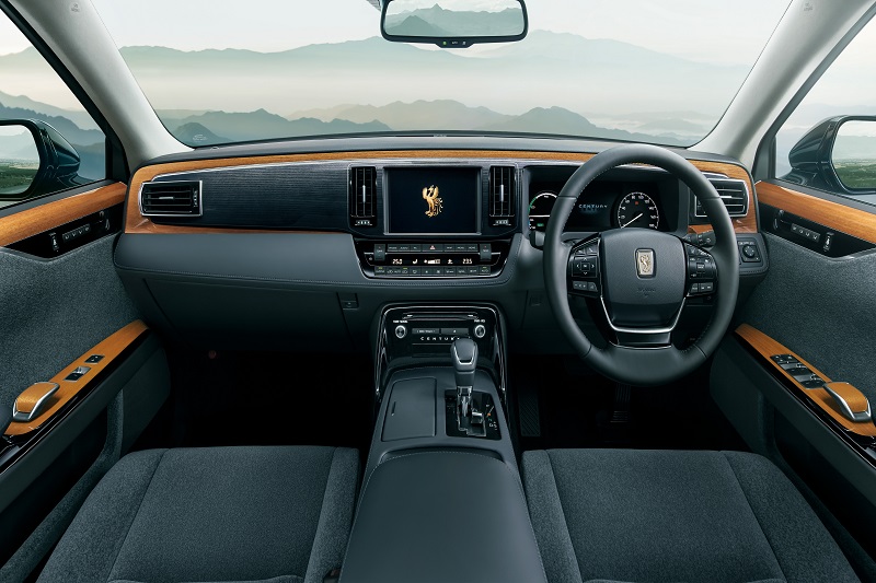 The interior of Toyota Century is finished in wood trim to create a distinct rear seating space, it also gets a raised ceiling design, and exclusive fabric with a slanting lattice motif to create a refined look. it also gets step-less adjustable power leg rest and massage function (in the left rear seat).