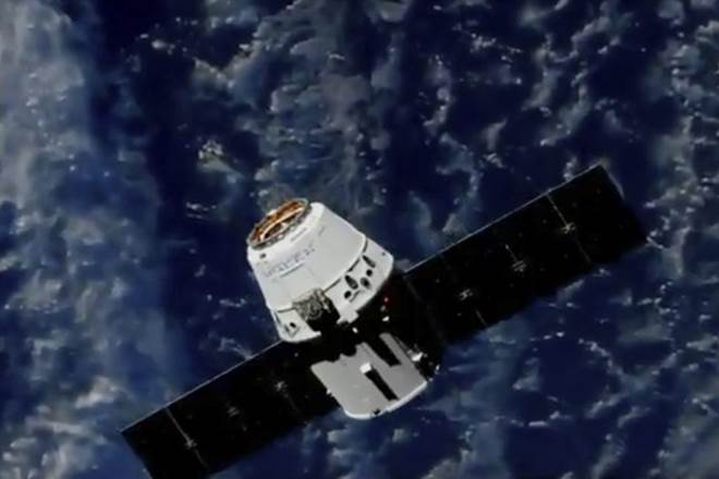 Station astronaut Ricky Arnold used a large mechanical arm to grab the Dragon capsule as the spacecraft soared above Quebec, Canada. (Nasa/AP)