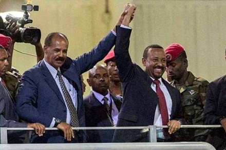 Eritrean President Isaias Afwerki (second left) and Ethiopia’s Prime Minister Abiy Ahmed (centre) hold hands as they wave at the crowds in Addis Ababa, Ethiopia on Sunday. (AP)