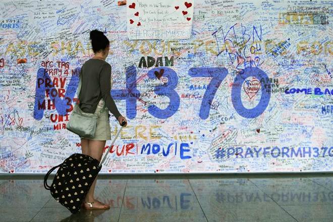 A woman looks at messages of support left for family members and passengers onboard the missing Malaysia Airlines Flight MH370 at the Kuala Lumpur International Airport (KLIA) in Sepang, outside Kuala Lumpur in 2014 (Reuters) A woman looks at messages of support left for family members and passengers onboard the missing Malaysia Airlines Flight MH370 at the Kuala Lumpur International Airport (KLIA) in Sepang, outside Kuala Lumpur in 2014 (Reuters)