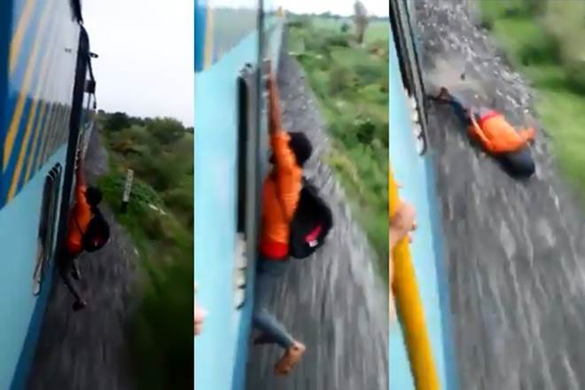In a shocking video that went viral on the Internet recently, this youngster is seen hanging outside the train. In a shocking video that went viral on the Internet recently, this youngster is seen hanging outside the train.