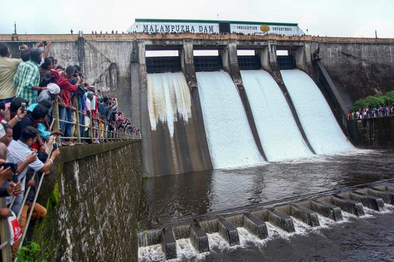In Palakkad, visitors look on as the four spillway shutters of the Malampuzha dam was opened on Wednesday, August 1. (PTI)