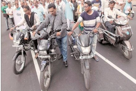 People take part in a protest against a hike in petrol prices in Shivajinagar, Pune (Express Photo)