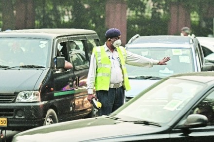 A traffic police officer in New Delhi. The author provides a new theoretical framework for laws to work better so that governments can craft more effective laws to achieve a fairer and more efficient society, (Bloomberg)