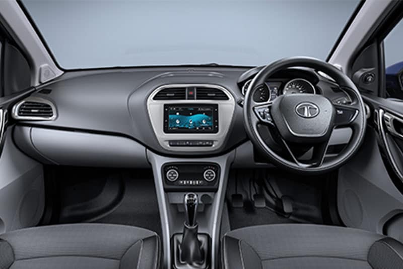 Inside the cabin, the 2018 Tata Tigor now gets a more premium cabin finished in black and grey colour scheme. It also gets segment first 7-inch touchscreen infotainment system from Harman and supports Android Auto and Bluetooth. It does not support Apple Car Play but does get inbuilt navigation.