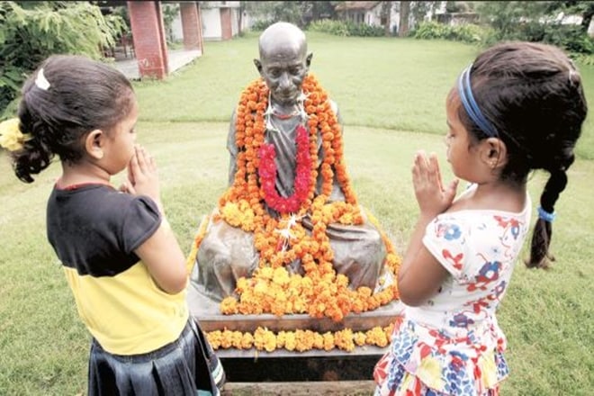 A file photo of children paying tribute to Mahatma Gandhi on his birth anniversary at Sabarmati Ashram, Ahmedabad (Express Photo)