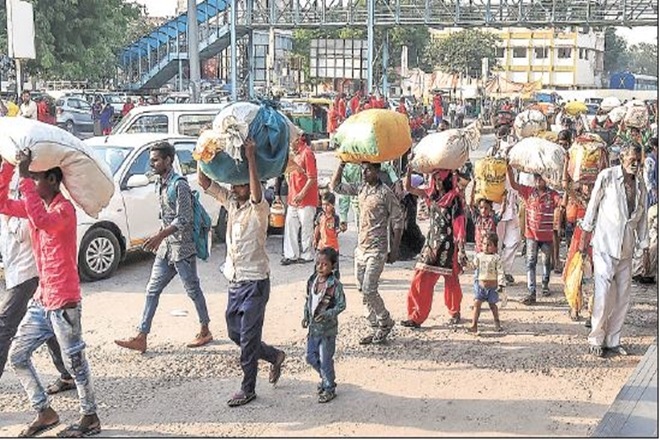 Workers from Uttar Pradesh and Bihar leave for their hometowns, in Ahmedabad on Monday (PTI) Workers from Uttar Pradesh and Bihar leave for their hometowns, in Ahmedabad on Monday (PTI)