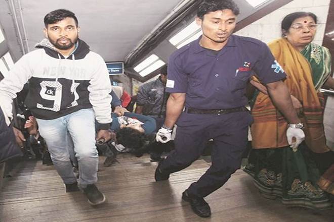 Rescue workers carry a Kolkata Metro passenger who had fallen ill due to the smoke, out of a station on Thursday. (PTI)