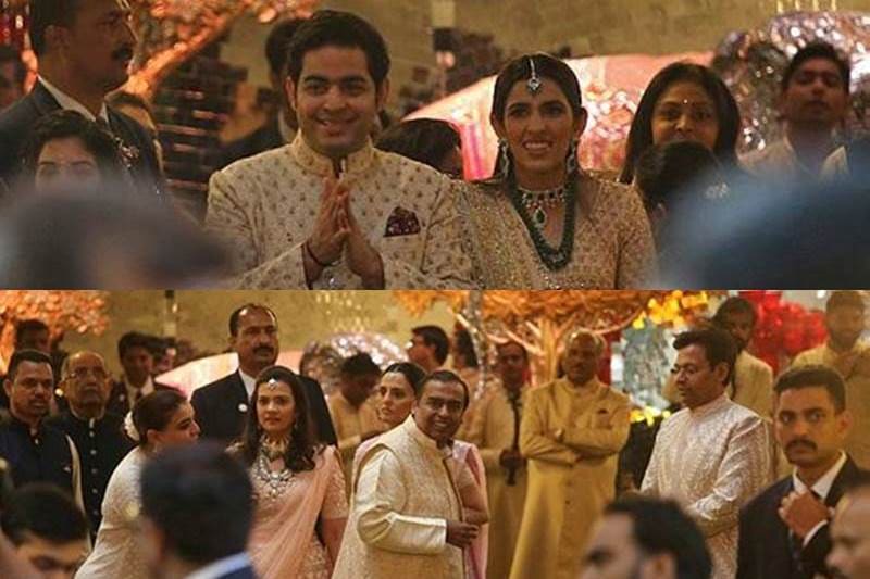 Akash Ambani with his fiancee Shloka Mehta and the Chairman of Reliance Industries Mukesh Ambani greet guests at the wedding ceremony of Isha Ambani. (Image: Reuters)