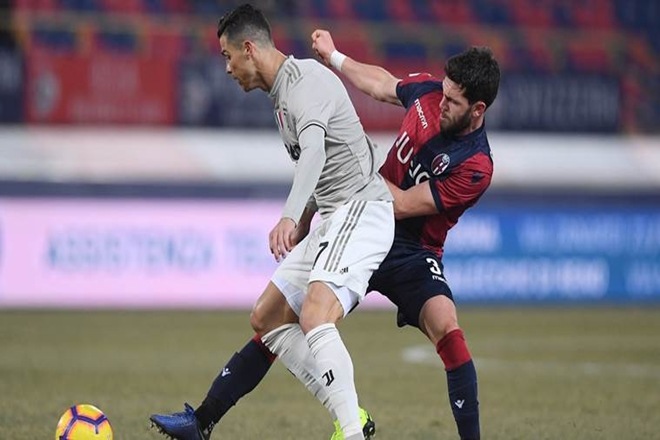 Juventus’ Cristiano Ronaldo in action with Bologna’s Arturo Calabresi REUTERS
