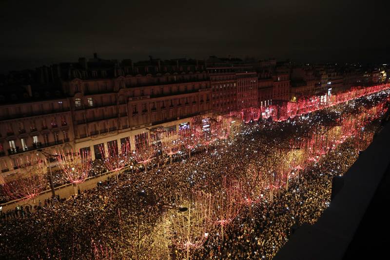 Revelers gather to attend the New Year's Day celebrations on the Champs Elysees, Paris. (AP Photo)