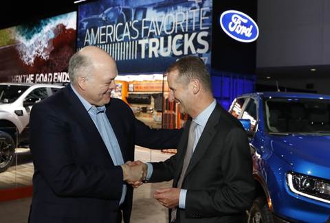 Ford Motor Co. President and CEO, Jim Hackett, left, meets with Dr. Herbert Diess, CEO of Volkswagen AG, Monday, Jan. 14, 2019, at the North American International Auto Show in Detroit. (AP Photo/Carlos Osorio)