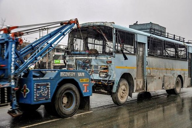 A damaged vehicle of CRPF being taken away from the site of suicide bomb attack in Pulwama (PTI Photo)