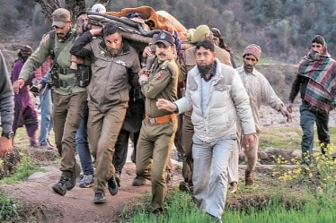 Police officials and locals carry an injured for treatment after firing and mortar shelling by the Pakistani army along the LoC in Krishna Ghati sector of J&K recently. (PTI)