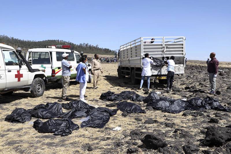 Black body bags were spread out nearby while Red Cross and other workers looked for remains. (AP Photo)