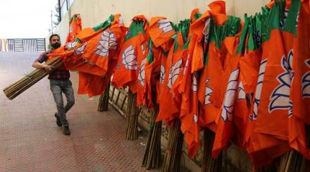 Bharatiya Janata Party (BJP) workers raise their party flag. Bharatiya Janata Party (BJP) workers raise their party flag.