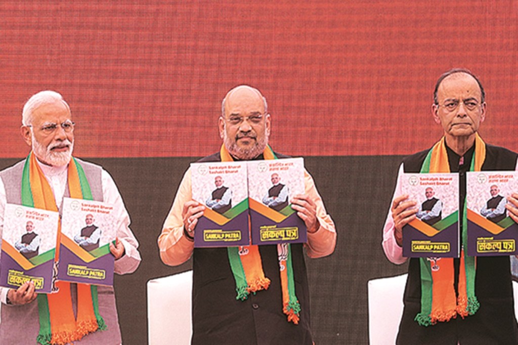From Left, Prime Minister Narendra Modi, Bharatiya Janata Party (BJP) president Amit Shah and Finace Minister Arun Jaitley release BJP's manifesto for the upcoming general elections in New Delhi on Monday. (Express Photo: Neeraj Priyadarshi)
