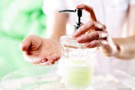 Woman dispenses soap for hands Woman dispenses soap for hands