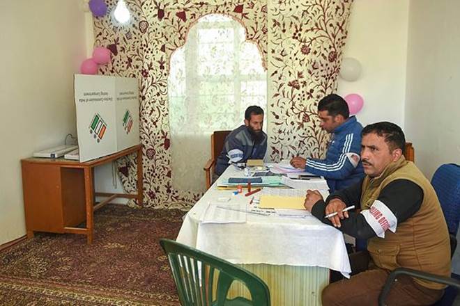 Poll officials at a polling station during the fifth phase of Lok Sabha elections, in Shopian district. (PTI Photo)