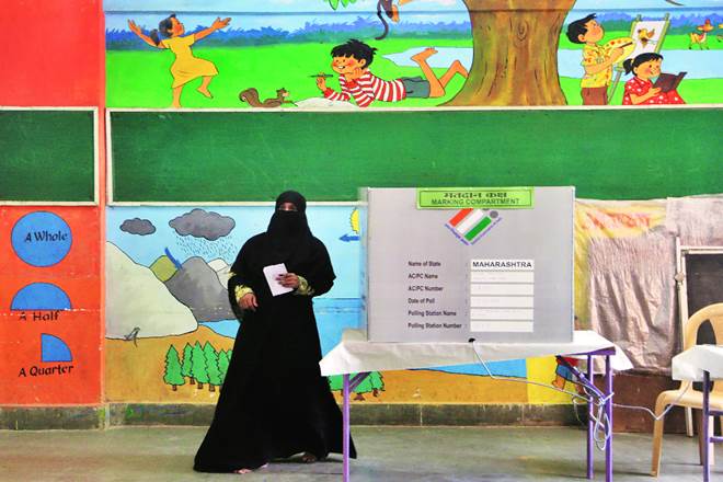 A woman walks back after casting her vote in Mumbai in April. In a democracy, the author says, the responsibility to bring about reforms lies with political parties. (AP Photo)