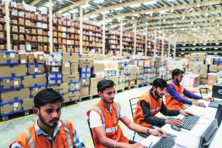 Workers at a Future Group warehouse in Nagpur. The conglomerate, the author says, allows managers to look at different ways of enhancing sales based on their own experience or intuition without having to get the nod from above. (Bloomberg)
