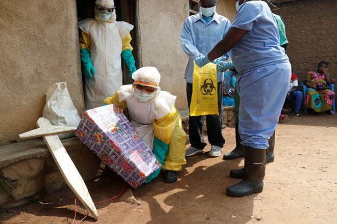 A healthcare worker holds a coffin for a baby suspected of dying of Ebola during the funeral in Beni, North Kivu Province of Democratic Republic of Congo, December 18, 2018. (Reuters) A healthcare worker holds a coffin for a baby suspected of dying of Ebola during the funeral in Beni, North Kivu Province of Democratic Republic of Congo, December 18, 2018. (Reuters)