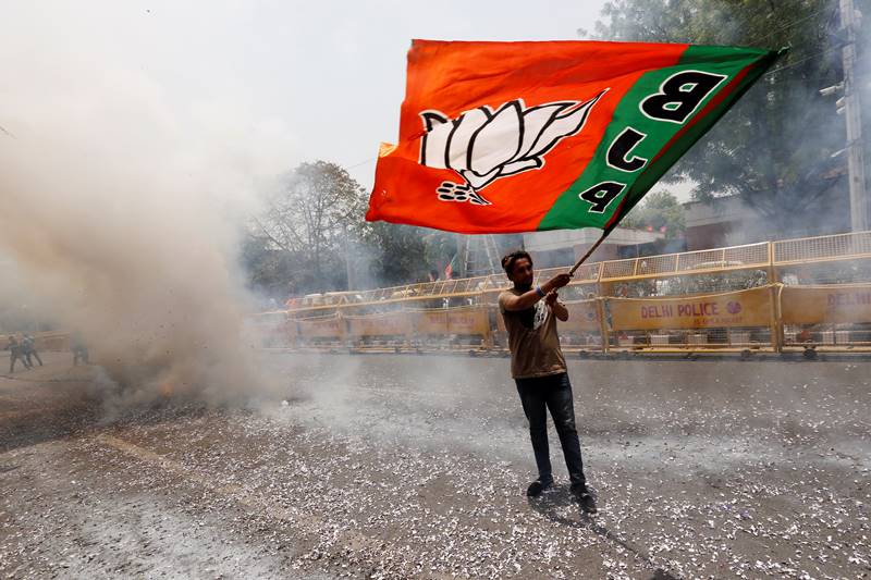 Lok Sabha Election Result: With the Bharatiya Janata Party (BJP) set to return to power, the party's headquarters wears a festive look, with reverberating slogans of 'Modi, Modi' rendering in the air, as jubilant party workers dance and distribute sweets in celebration. While the counting of votes is still going on for the Lok Sabha elections 2019, but all trends till now indicate clear majority for NDA (National Democratic Alliance) government. As soon as the trends of vote counts emerged, indicating the convincing performance of the BJP, party workers gathered in large numbers at the headquarters on Deendayal Upadhyaya Marg, with their saffron flags fluttering in the air. (photo: Reuters)