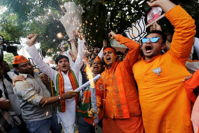 Many BJP supporters burst crackers in front of the party office, while others danced and distributed 'ladoos' as slogans of 'Modi, Modi' and 'Jai Shri Ram' consistently reverberated in the air. (photo: Reuters)