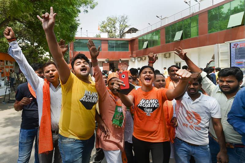 As poll trends continued to pour in late afternoon, an army of BJP supporters and workers who gathered at the headquarters, danced in the courtyard and wore t-shirts with messages such as 'Chowkidar Phir Se', 'NaMo Again', 'Phir ek baar Modi Sarkar'. (photo: PTI)