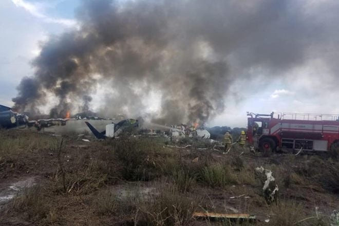 Note: This image is from Mexico's northern state of Durango, July 31, 2018, in which firefighters douse a fire as smoke billows above the site where an Aeromexico-operated Embraer passenger jet which crashed Proteccion Civil Durango/via REUTERS Note: This image is from Mexico's northern state of Durango, July 31, 2018, in which firefighters douse a fire as smoke billows above the site where an Aeromexico-operated Embraer passenger jet which crashed Proteccion Civil Durango/via REUTERS