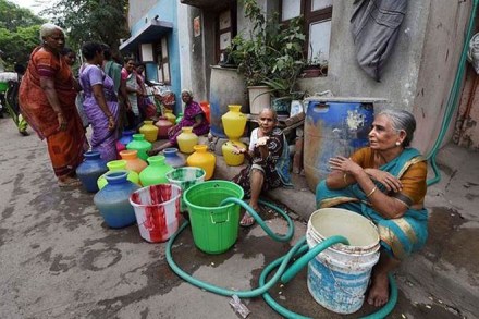 Women queue to fill their vessels with potable water from a handpump, in Chennai (PTI Photo) Women queue to fill their vessels with potable water from a handpump, in Chennai (PTI Photo)