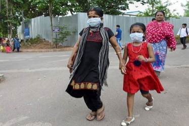 People wear masks as a protective measure after reports of outbreak of Nipah virus (PTI Photo)