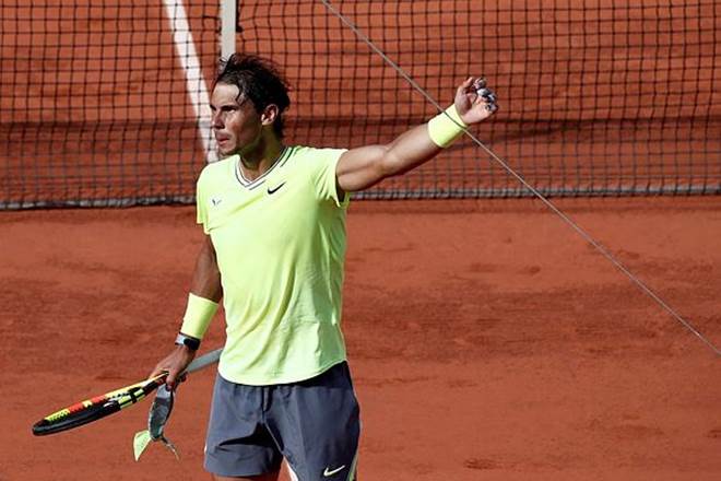Spain's Rafael Nadal hits his harm on the TV camera wire as he celebrates after winning his fourth round match against Argentina's Juan Ignacio Londero