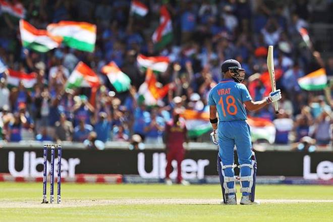 Virat Kohli raises his bat after scoring a fifty against West Indies. (Photo AP)