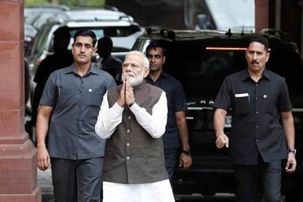 Prime Minister Narendra Modi walks to speak with the media as he arrives to attend the opening day of the parliament session in Delhi. (PTI)