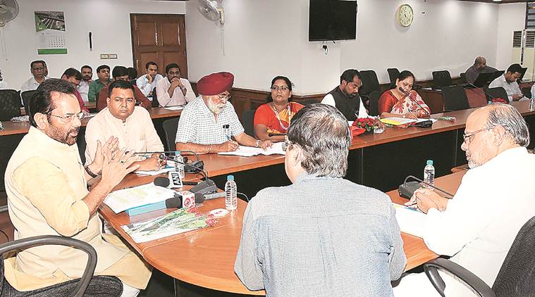 Minority Affairs minister Mukhtar Abbas Naqvi with Senior Assistant Editor Abantika Ghosh in The Indian Express newsroom GAJENDRA YADAV