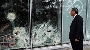 Andrew Leung, president of the Legislative Council, looks at damaged glass panels, a day after protesters broke into the councul building, in Hong Kong (Reuters Photo)