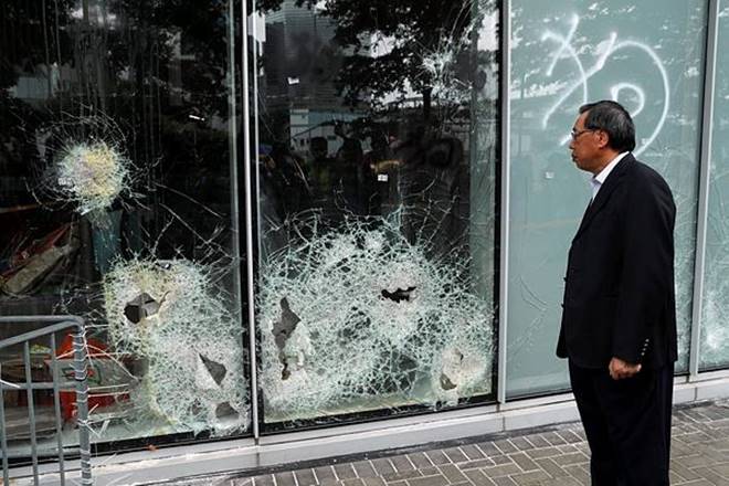 Andrew Leung, president of the Legislative Council, looks at damaged glass panels, a day after protesters broke into the councul building, in Hong Kong (Reuters Photo)