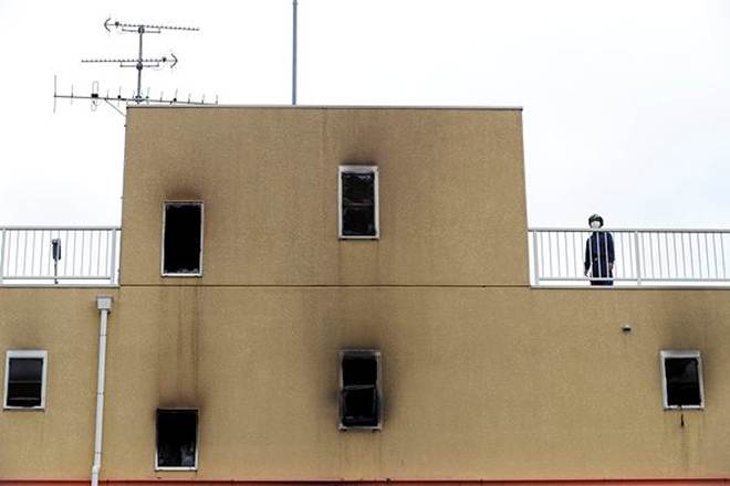 A firefighter is seen near the roof of the torched Kyoto Animation building (Reuters photo)