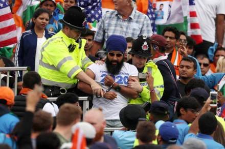 A fan being arrested by British police at Old Trafford during the India vs New Zealand semifinal. 