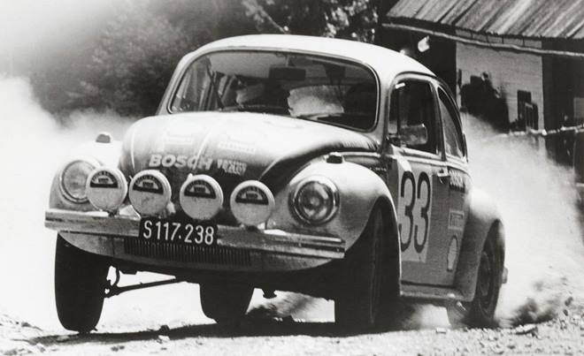 Re-launched as a civilian carmaker under supervision of the British occupation authorities, the Volkswagen factory was transferred in 1949 to the Germany government and the state of Lower Saxony, which still owns part of the company. By 1955, the millionth Beetle — officially called the Type 1 — had rolled off the assembly line in Wolfsburg. (Pictured here is a Beetle stomping authority on rally stage)