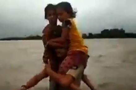 The video was shared wildly after news agency ANI has uploaded a 30-second clip of Jadega walking through the flood water with the two children on his shoulders. (ANI image)
