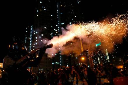 Riot police fire tear gas to disperse anti-extradition bill protesters after a march to demand democracy and political reforms, at Wong Tai Sin in Hong Kong