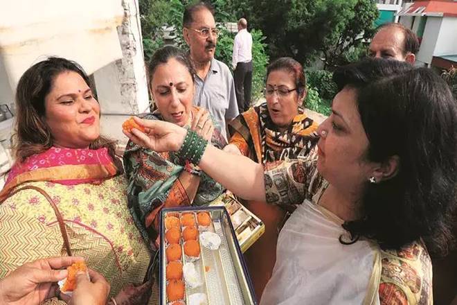 A group of Kashmiri Pandits celebrate in Lucknow on Monday. (Express photo by Vishal Srivastav)