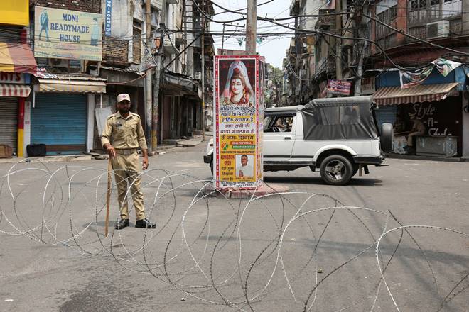 A security personnel stands guard along a deserted street during restrictions in Jammu. (Reuters)